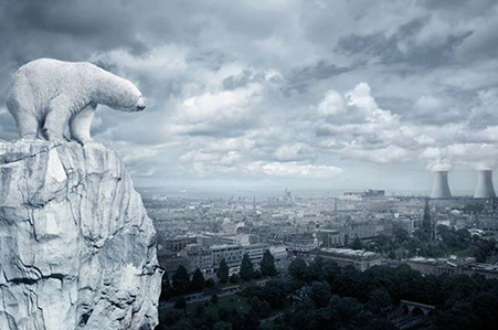 Polar bear on a cliff above an industrial city.